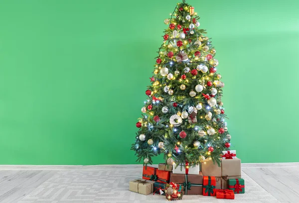 Bela Árvore Natal Decorada Caixas Presente Perto Parede Verde — Fotografia de Stock