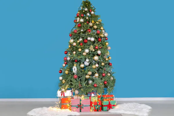 Hermoso Árbol Navidad Decorado Cajas Regalo Cerca Pared Azul —  Fotos de Stock