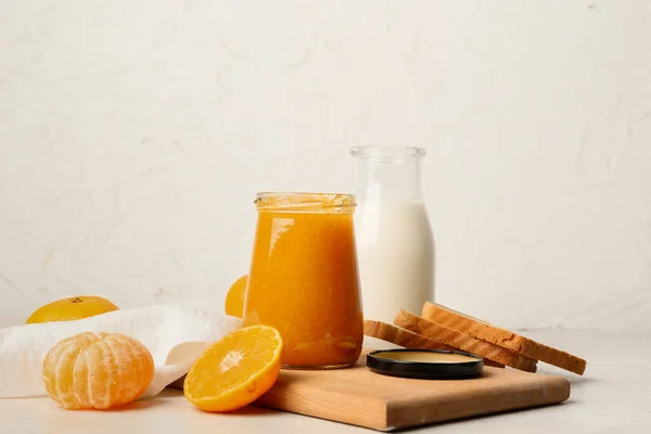 Glas Mit Leckerer Mandarinenmarmelade Und Milch Auf Hellem Hintergrund — Stockfoto