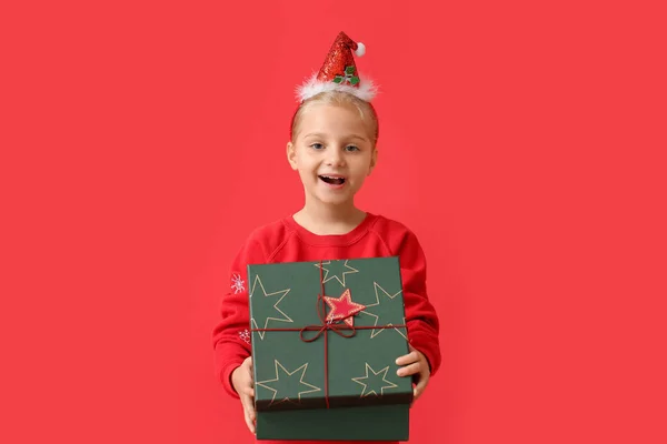 Little Girl Opening Christmas Gift Color Background — Stock Photo, Image