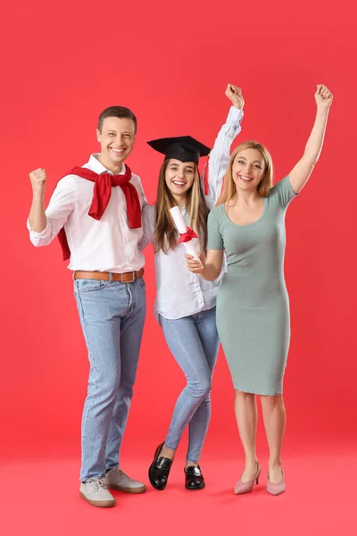 Happy Female Graduation Student Her Parents Color Background — Stock Photo, Image