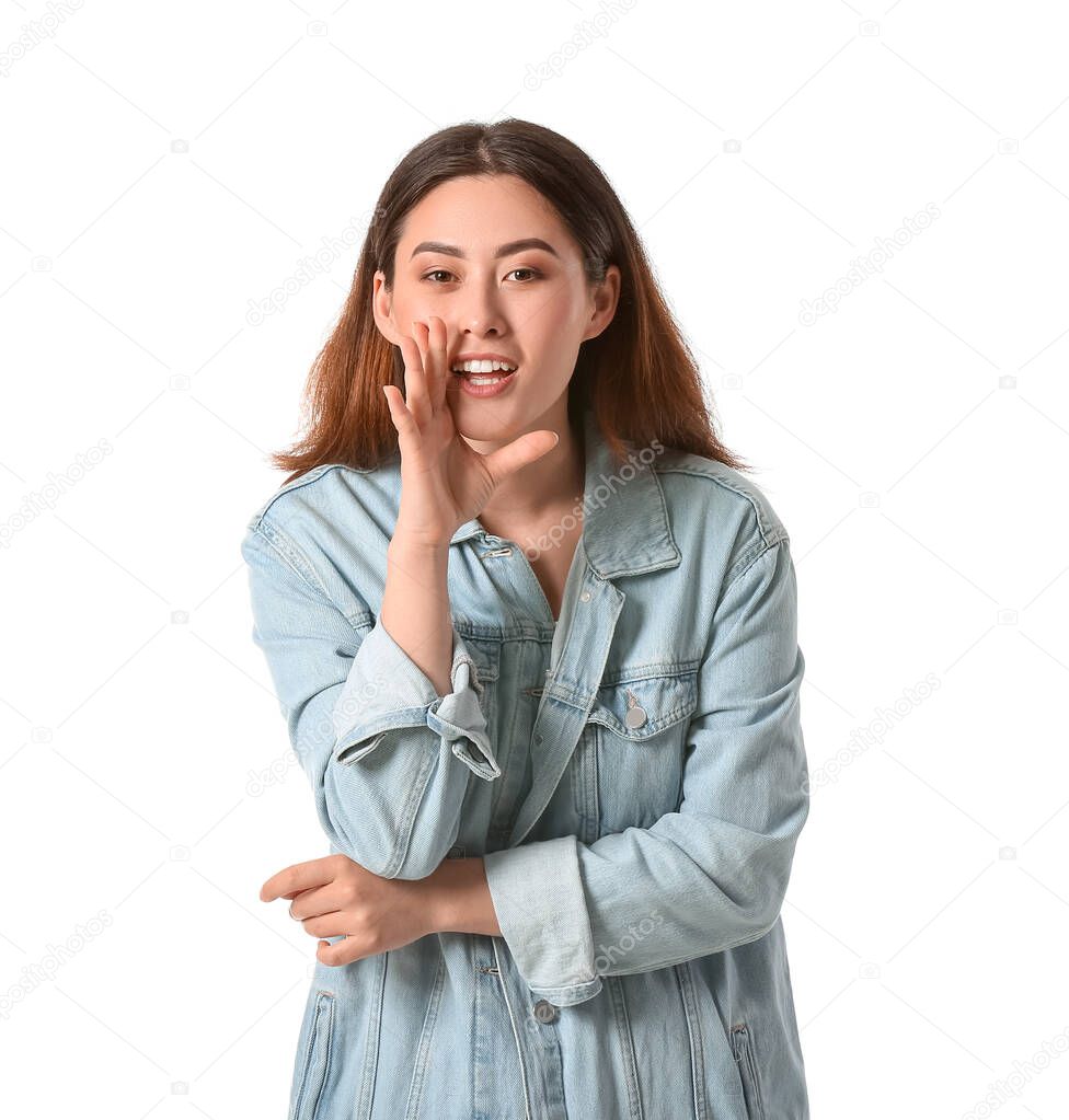 Young gossiping Asian woman on white background