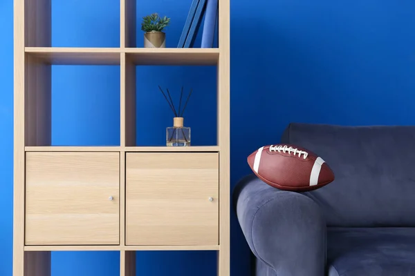 Sofa Rugby Ball Shelving Unit Blue Wall — Stock Photo, Image