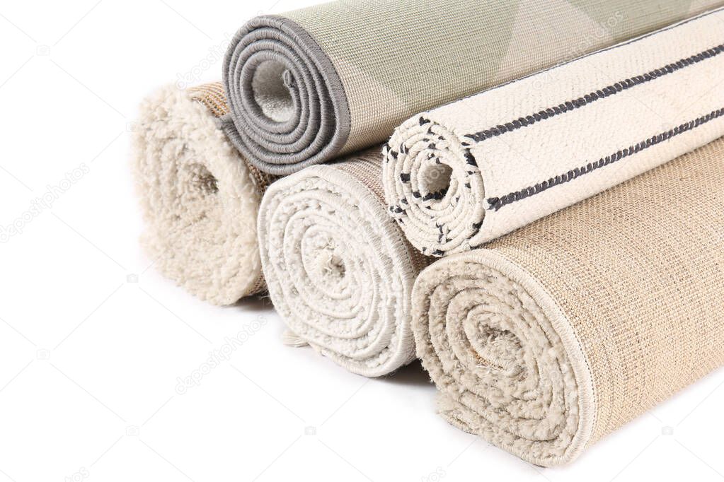 Different rolled carpets isolated on white