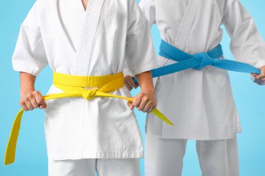 Renkli arka planda karategi yapan küçük çocuklar.