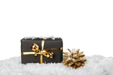 Noel hediyesi ve beyaz arka planda karlı çam kozalağı