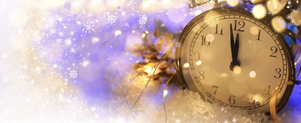 Christmas clock with snow on color background with space for text