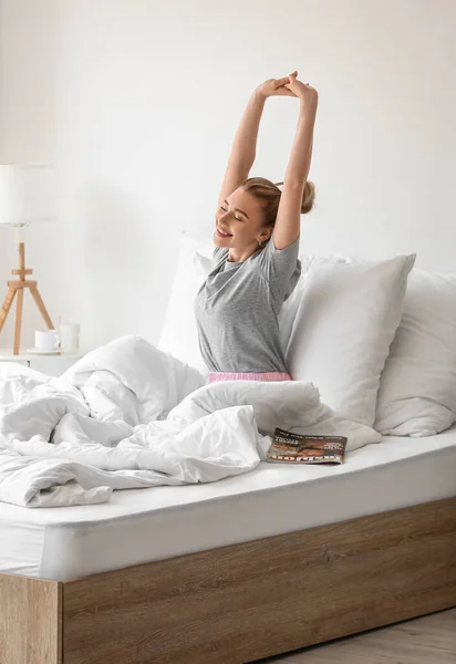 Morning of beautiful woman stretching on bed