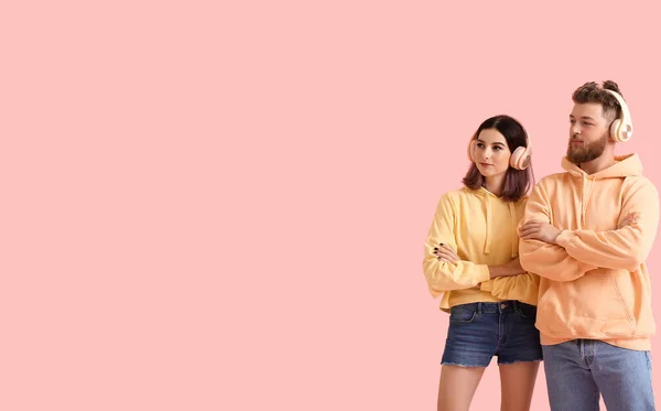 Renkli Arka Planda Müzik Dinleyen Kapüşonlu Havalı Genç Çift — Stok fotoğraf