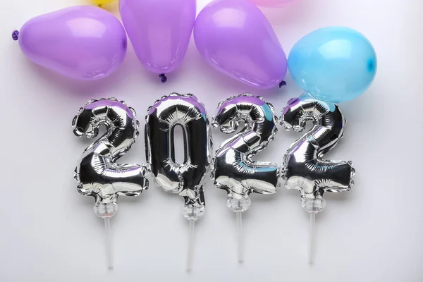 Figure 2022 made of silver balloons on light background