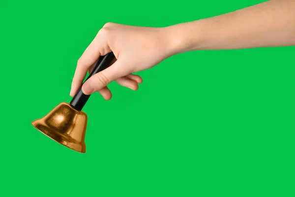 Female Hand Christmas Bell Green Background Closeup — Stock Photo, Image