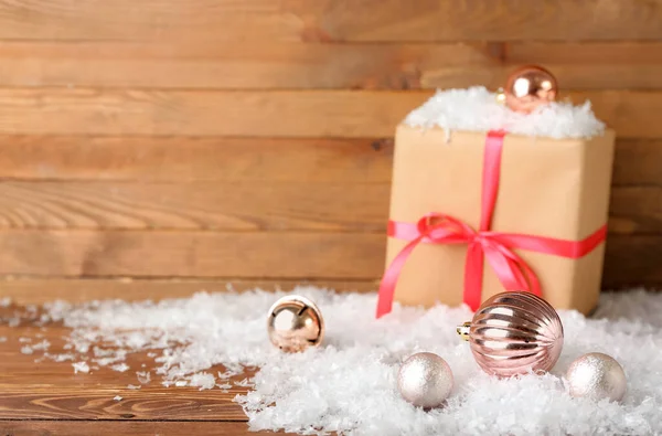 Christmas Balls Gift Box Heap Snow Wooden Background — Stock Photo, Image