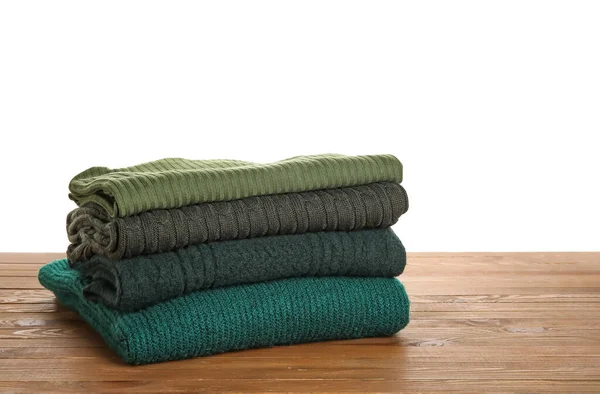 Stack Different Green Sweaters Wooden Table White Background — Stock Photo, Image