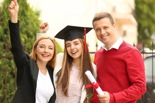 卒業式の日に両親と幸せな若い女性 — ストック写真
