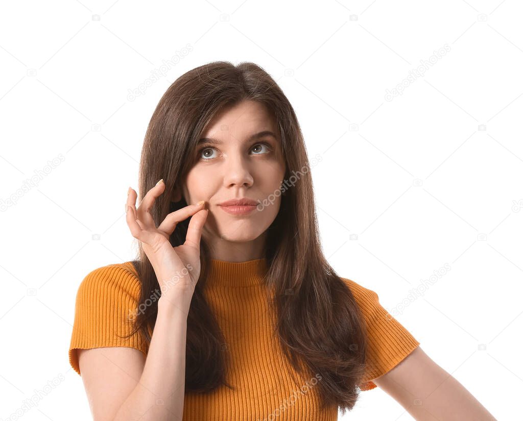Young woman zipping her mouth on white background