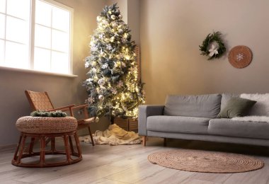 Modern oturma odasının içinde güzel bir Noel ağacı ve kanepesi var.