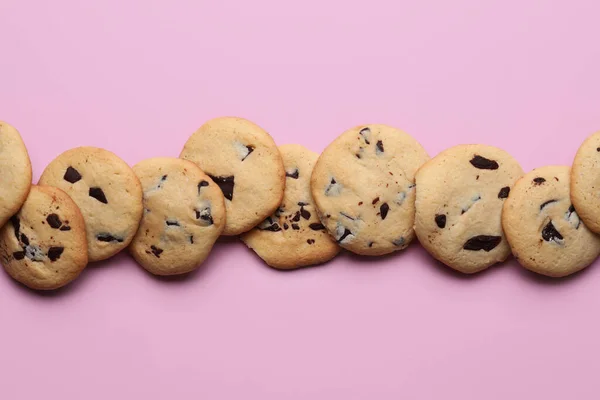 ピンクの背景にチョコレートチップとおいしいクッキー — ストック写真