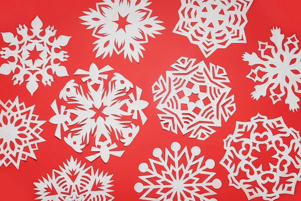 赤い背景に美しい紙の雪片 — ストック写真