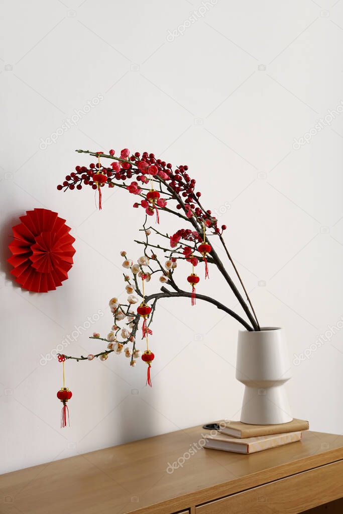 Table with beautiful decorations for Chinese New Year celebration in room