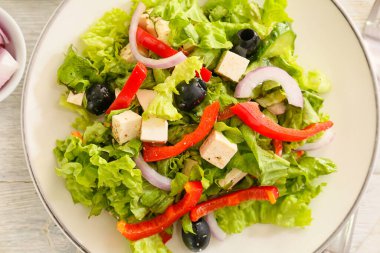 Açık ahşap arka planda taze Yunan salatası, yakın plan.