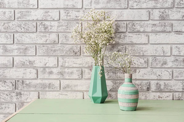 Vases Beautiful Gypsophila Flowers Table Brick Wall — Stock Photo, Image