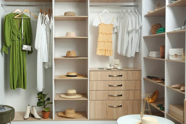 Modern wardrobe with stylish clothes, shoes and accessories