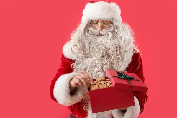 Weihnachtsmann Mit Leckeren Plätzchen Geschenkbox Auf Farbigem Hintergrund — Stockfoto