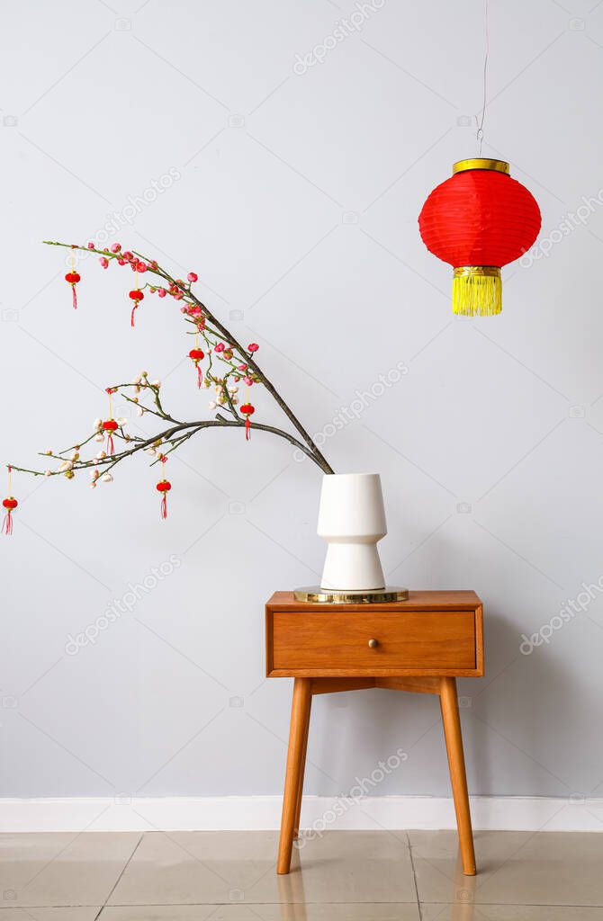 Table with beautiful decorations for Chinese New Year celebration in room