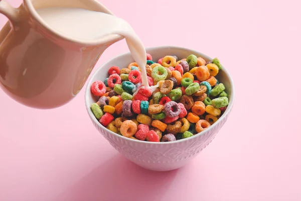 Pouring Milk Bowl Colorful Cereal Rings Pink Background — Stock Photo, Image