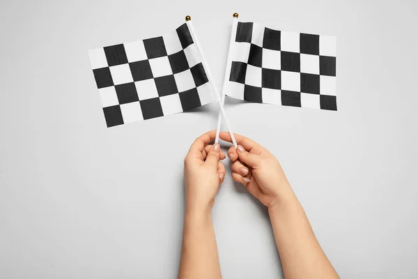 Female Hands Racing Flags Light Background — Stock Photo, Image