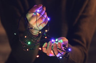 Noel ışıkları tutan kadın, yakın plan.