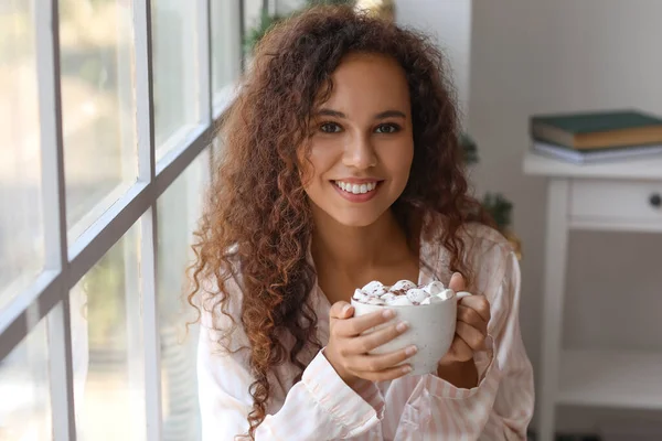 Young African American Woman Cup Hot Cocoa Marshmallows Window Christmas — Stock Photo, Image