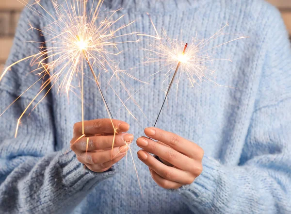 Woman Blue Sweater Holding Christmas Sparklers Closeup — Stock Photo, Image