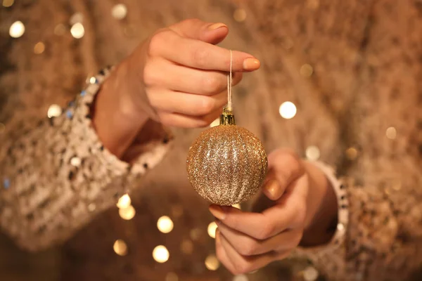 Woman Holding Golden Christmas Ball Closeup — Stock Photo, Image