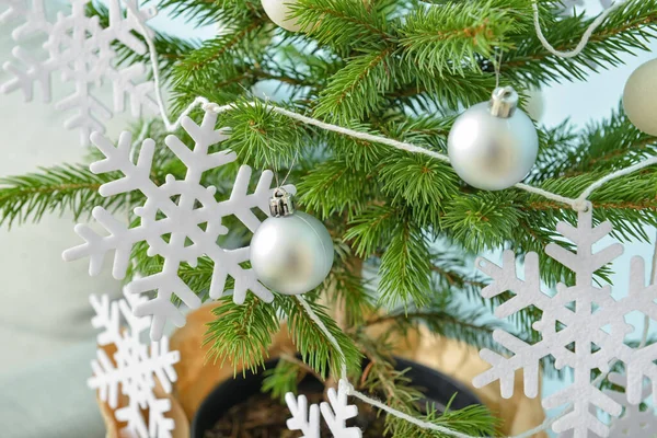雪の結晶とボールで飾られた美しいクリスマスツリー屋内 — ストック写真