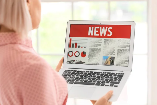 Mature Woman Reading Newspaper Laptop Home Closeup — Stock Photo, Image