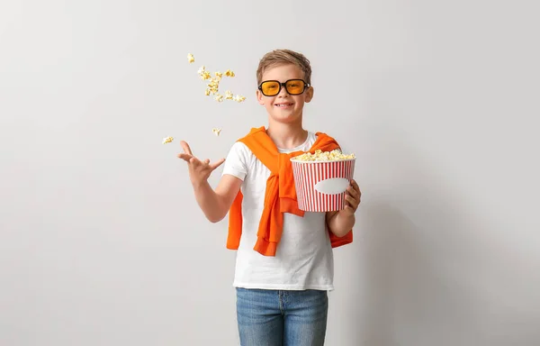 Little Boy Eyeglasses Throwing Tasty Popcorn Light Background — Stock Photo, Image