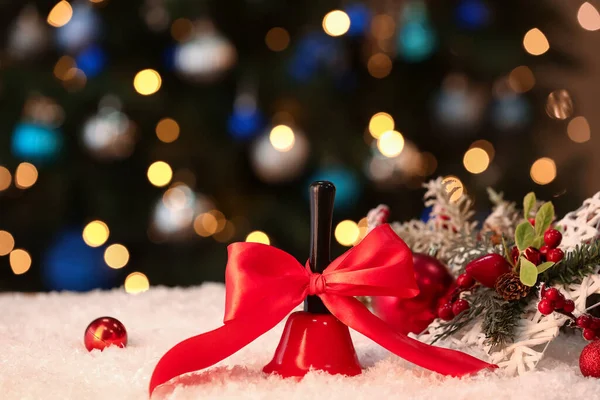 Campana Navidad Con Lazo Rojo Sobre Nieve Contra Luces Borrosas —  Fotos de Stock