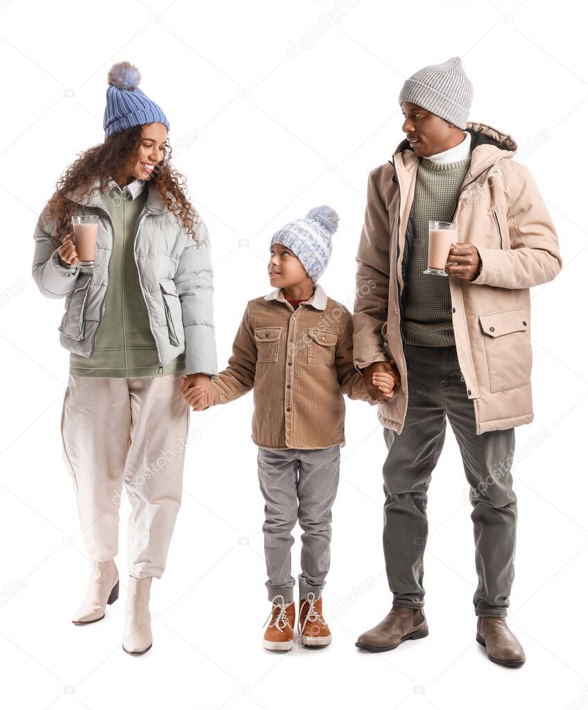 African-American family in winter clothes and with tasty hot chocolate on white background