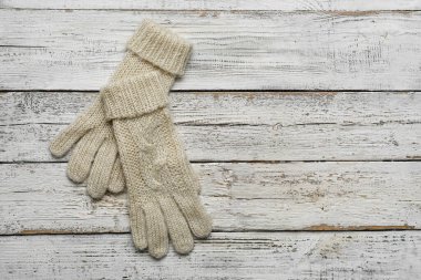 Hafif ahşap arka planda bir çift sıcak eldiven.