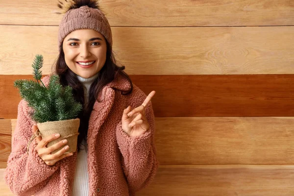 Pretty Young Woman Winter Clothes Christmas Tree Pointing Something Wooden — Stock Photo, Image