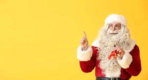 Santa Claus Christmas Bell Pointing Something Yellow Background Space Text — Stock Photo, Image