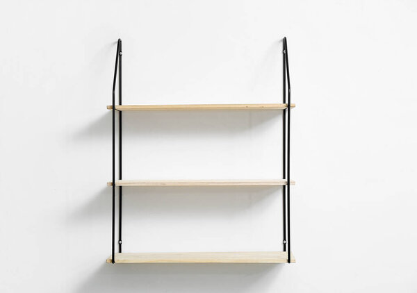 Modern empty shelves hanging on light wall