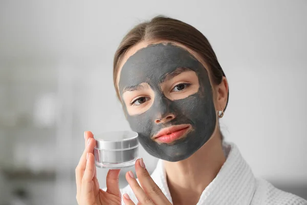 自宅で彼女の顔に活性炭マスクを持つ若い女性 — ストック写真