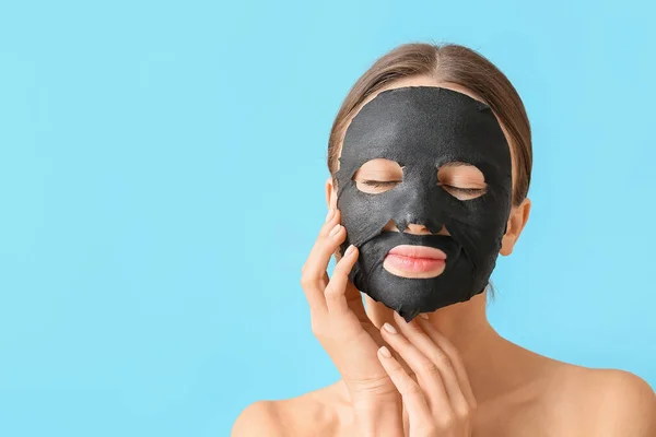 Young Woman Activated Charcoal Mask Her Face Color Background — Stock Photo, Image