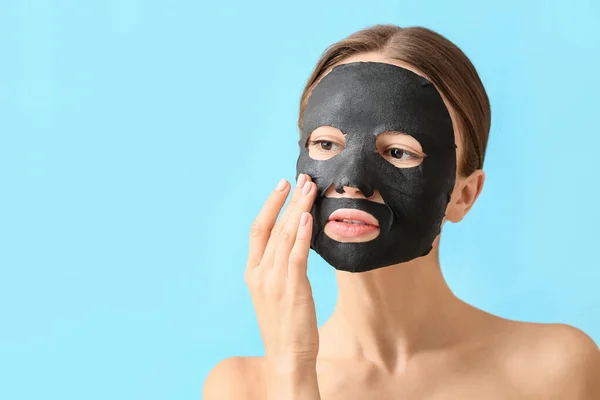 Young Woman Activated Charcoal Mask Her Face Color Background — Stock Photo, Image