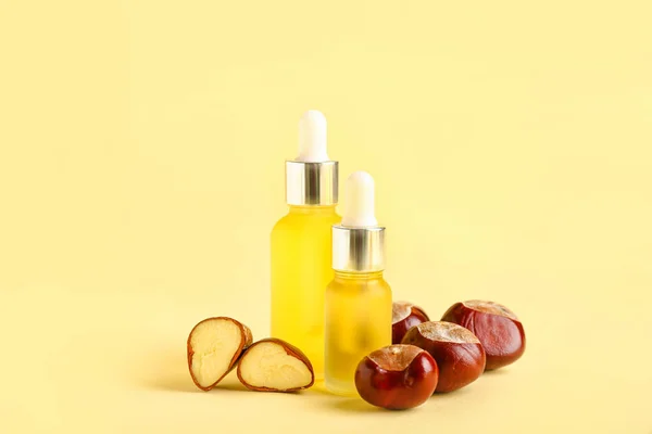 Bottles Essential Oil Chestnuts Color Background — Stock Photo, Image