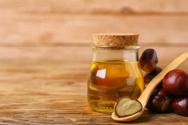 Bottle Essential Oil Fresh Chestnuts Wooden Background Closeup — Stock Photo, Image