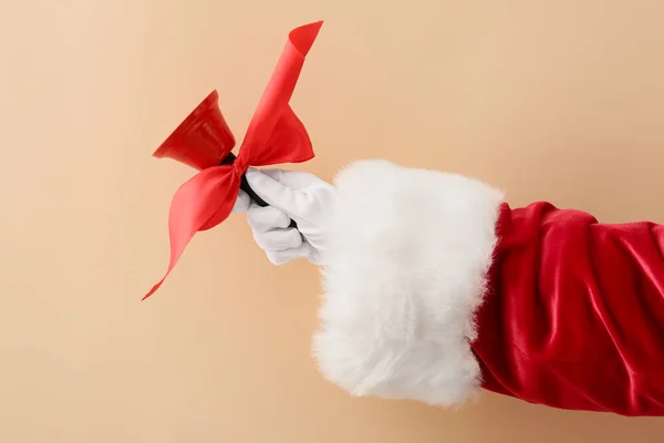 Santa Hand Christmas Bell Beige Background — Stock Photo, Image