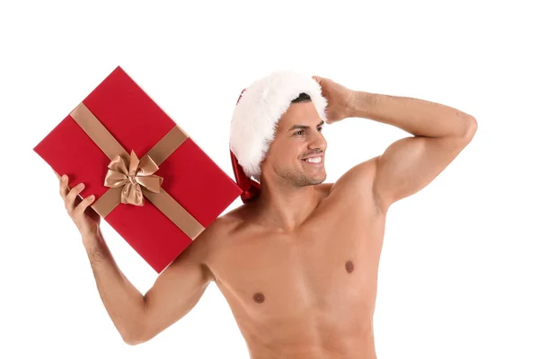 セクシー若いです男でサンタ帽子とととともにクリスマスギフト上の白い背景 — ストック写真